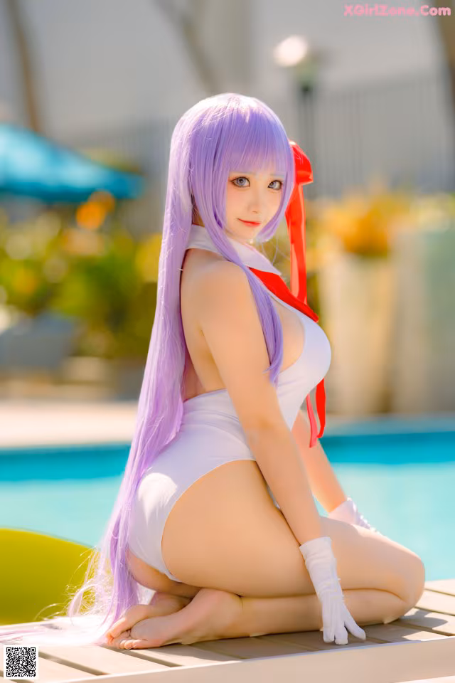 A woman with long purple hair sitting on the edge of a pool.