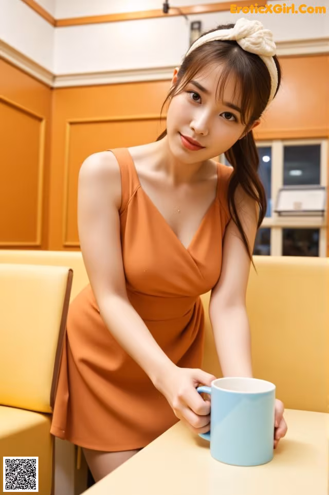 A woman sitting at a table with a cup of coffee.