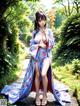 A woman in a blue kimono is posing for a picture.