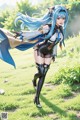 A woman with long blue hair is standing in the grass.