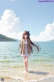 A girl walking on the beach with long hair.