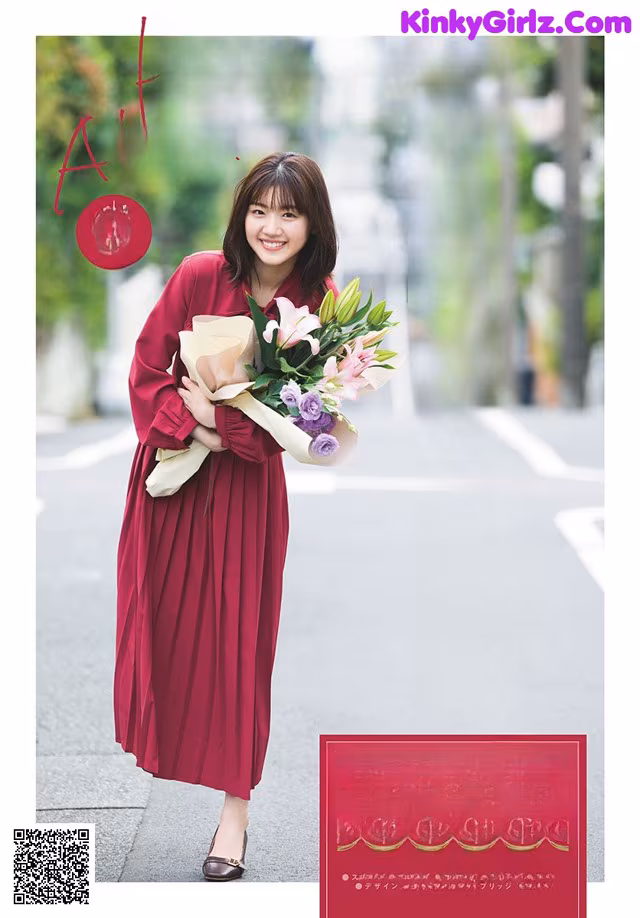 A woman in a red dress holding a bouquet of flowers.