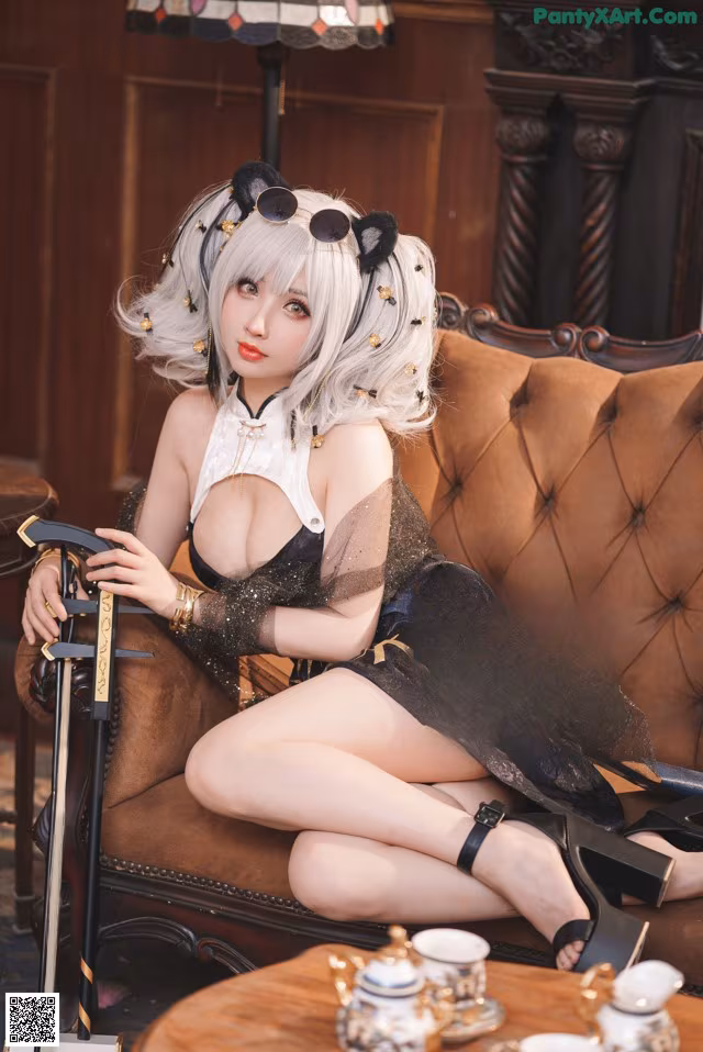 A woman sitting on a couch with a cane.