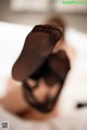 A close up of a woman's feet in black stockings.