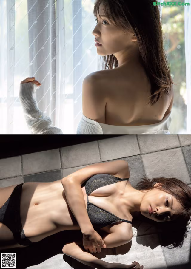 A woman laying on the floor next to a window.