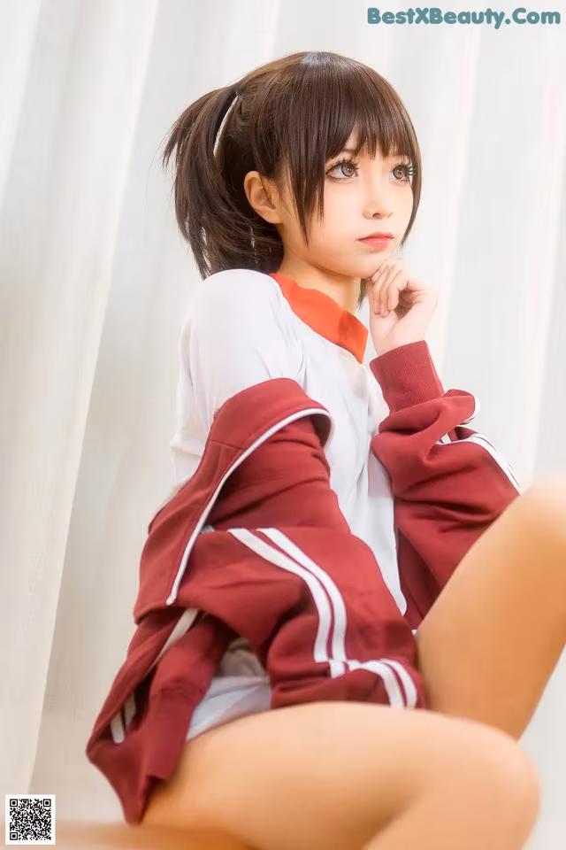 A woman in a red and white uniform sitting on a chair.